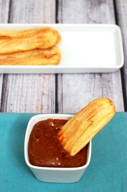 Snack on baked churros dipped in dulce de leche this Cinco de Mayo! | theredheadbaker.com