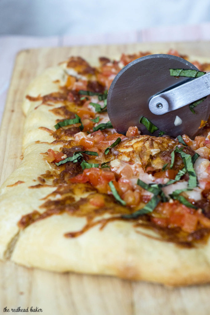Bruschetta pizza is loaded with fresh summer tomatoes, basil and garlic over lots of melted mozzarella cheese. What better flavor for summer pizza? #ProgressiveEats