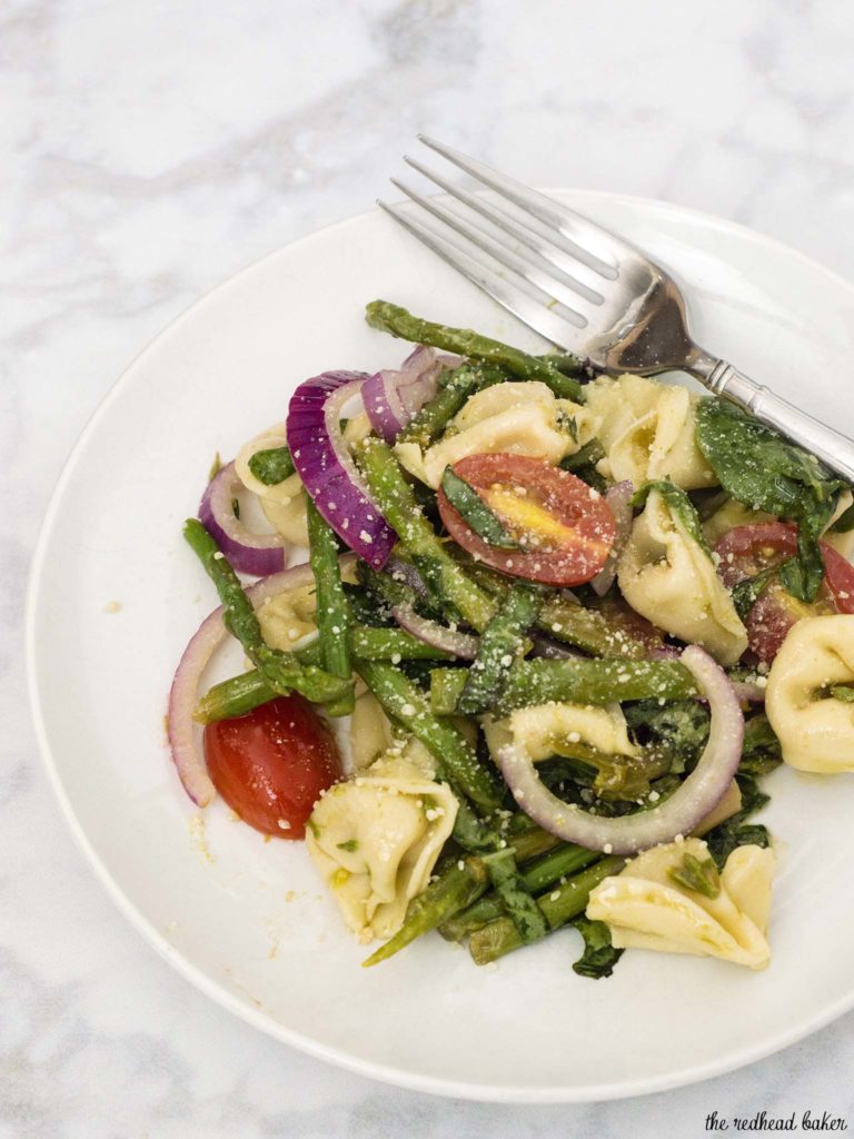 Tomato tortellini salad is my new favorite summer dinner! It combines lots of fresh, healthy vegetables, and comes together in under 30 minutes!