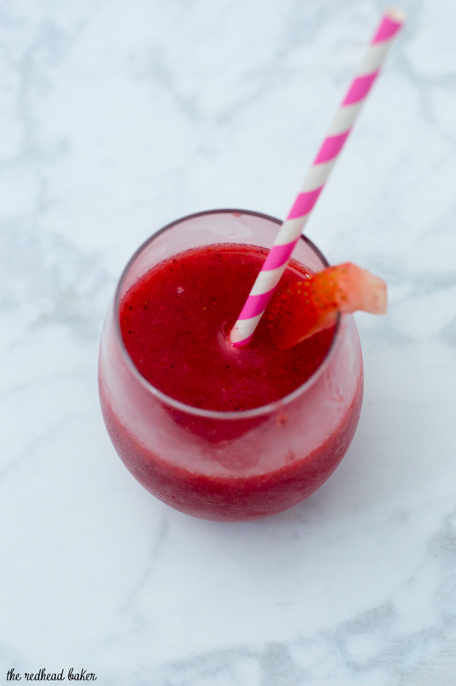 Strawberry sangria slushies are a fun frozen cocktail — white wine blends with frozen strawberries and triple sec for a delicious summer treat!