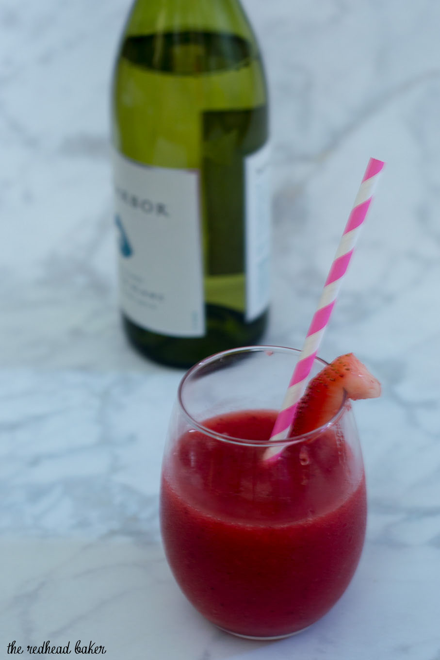 Strawberry sangria slushies are a fun frozen cocktail — white wine blends with frozen strawberries and triple sec for a delicious summer treat!