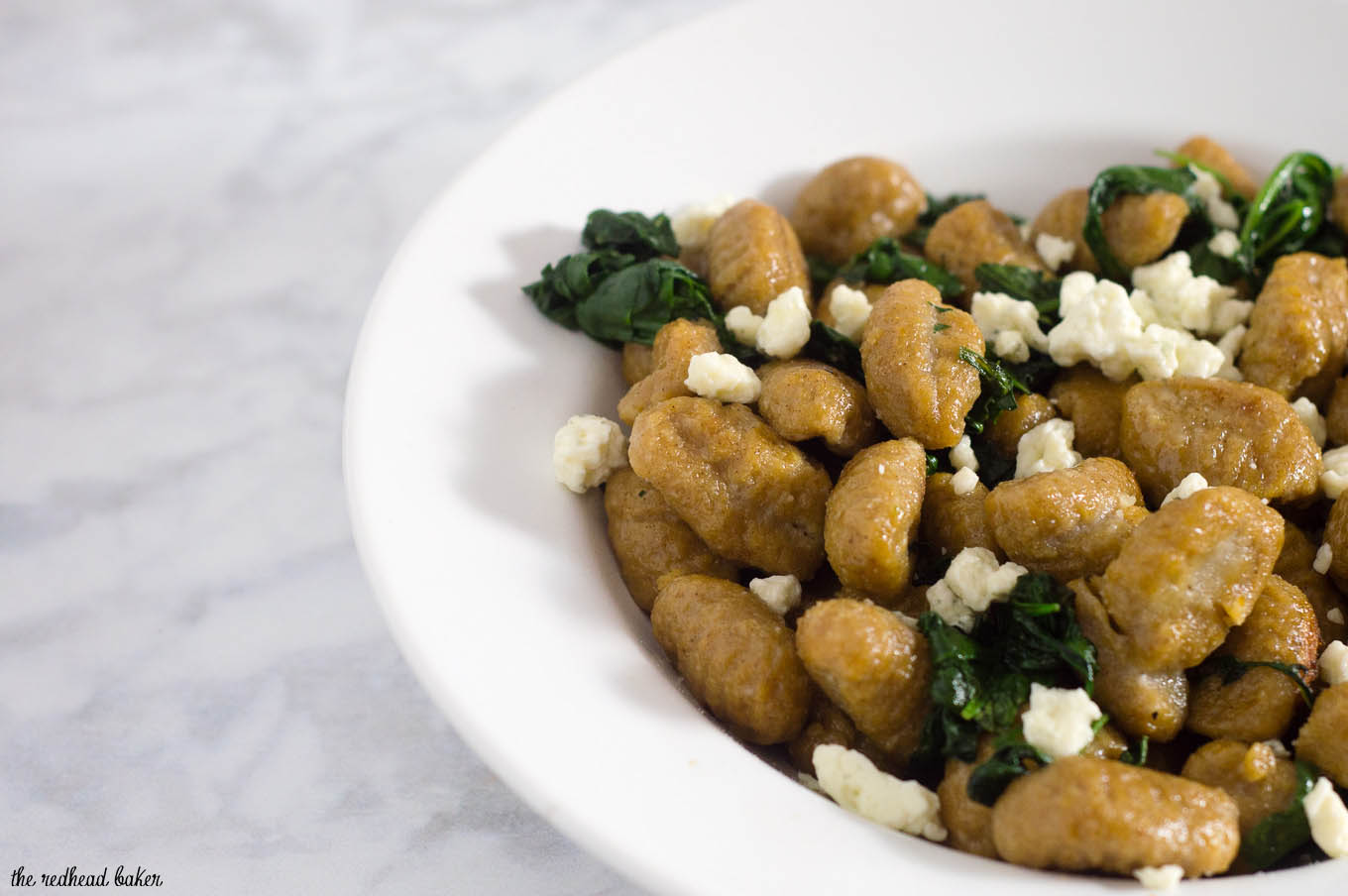 Pumpkin gnocchi and spinach with sage brown butter sauce is a hearty vegetarian meal full of flavor. You won't miss the meat! #SundaySupper