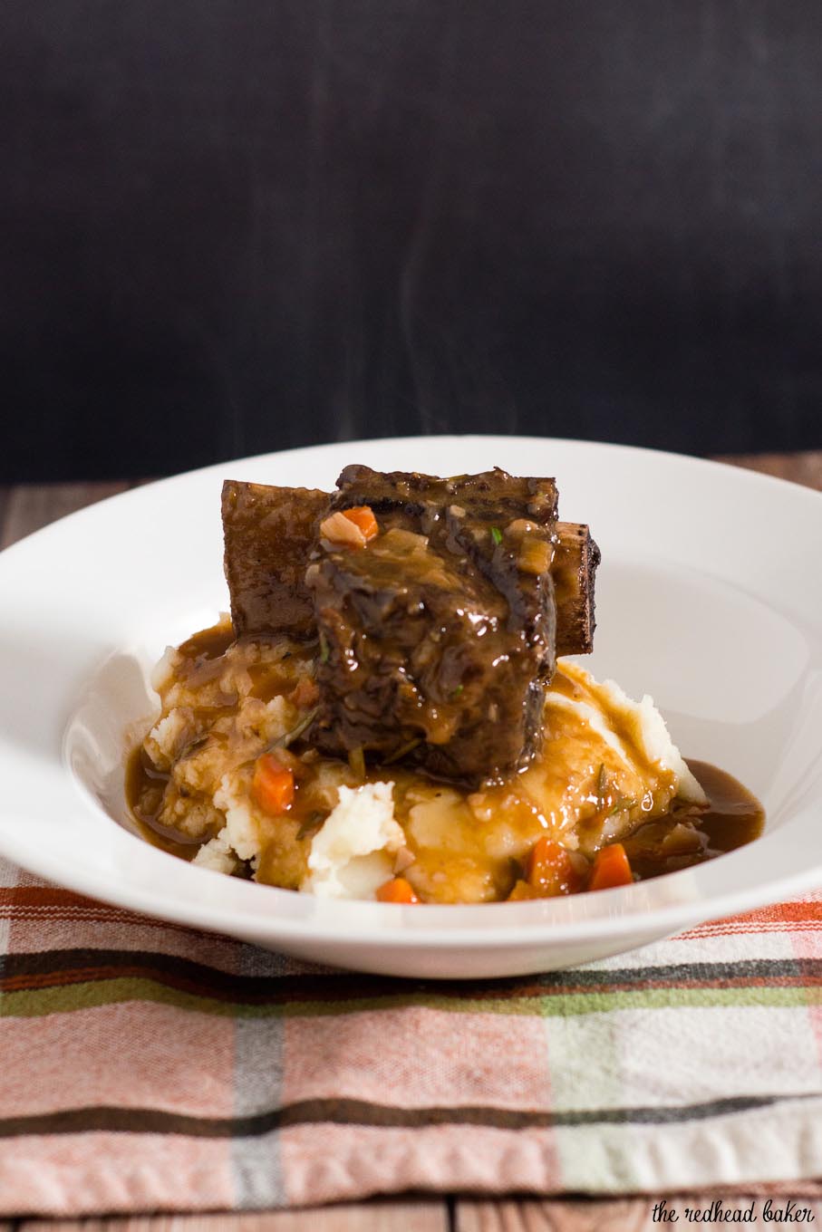 Braised short ribs become fall-off-the-bone tender in a mixture of red wine, beef stock, and garlic. Serve over mashed potatoes for a true comfort meal.