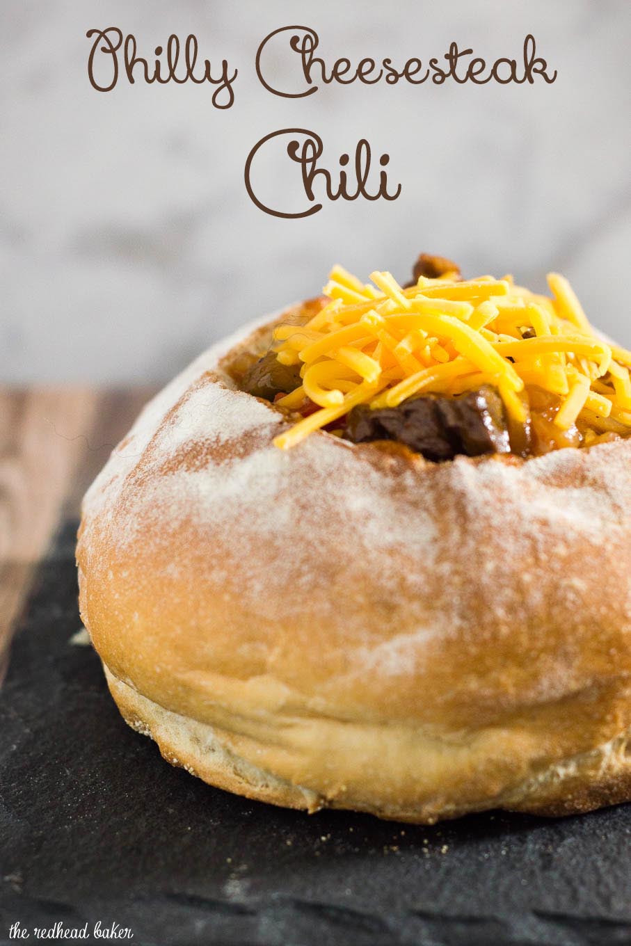 Philly cheesesteak chili has all the flavors of a traditional cheesesteak sandwich, topped with cheese and served in a hollowed-out bread bowl.