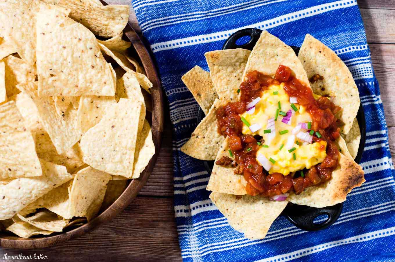 Chilaquiles are a Mexican brunch dish that will really wake you up! Tortilla chips are topped with scrambled eggs, spicy chorizo, salsa and cheese. #BrunchWeek
