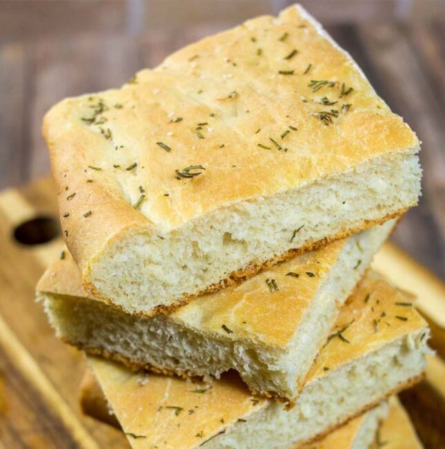 Focaccia is an Italian flat bread similar to the crust of Sicilian pizza. It is moist, chewy, and topped with savory rosemary. 