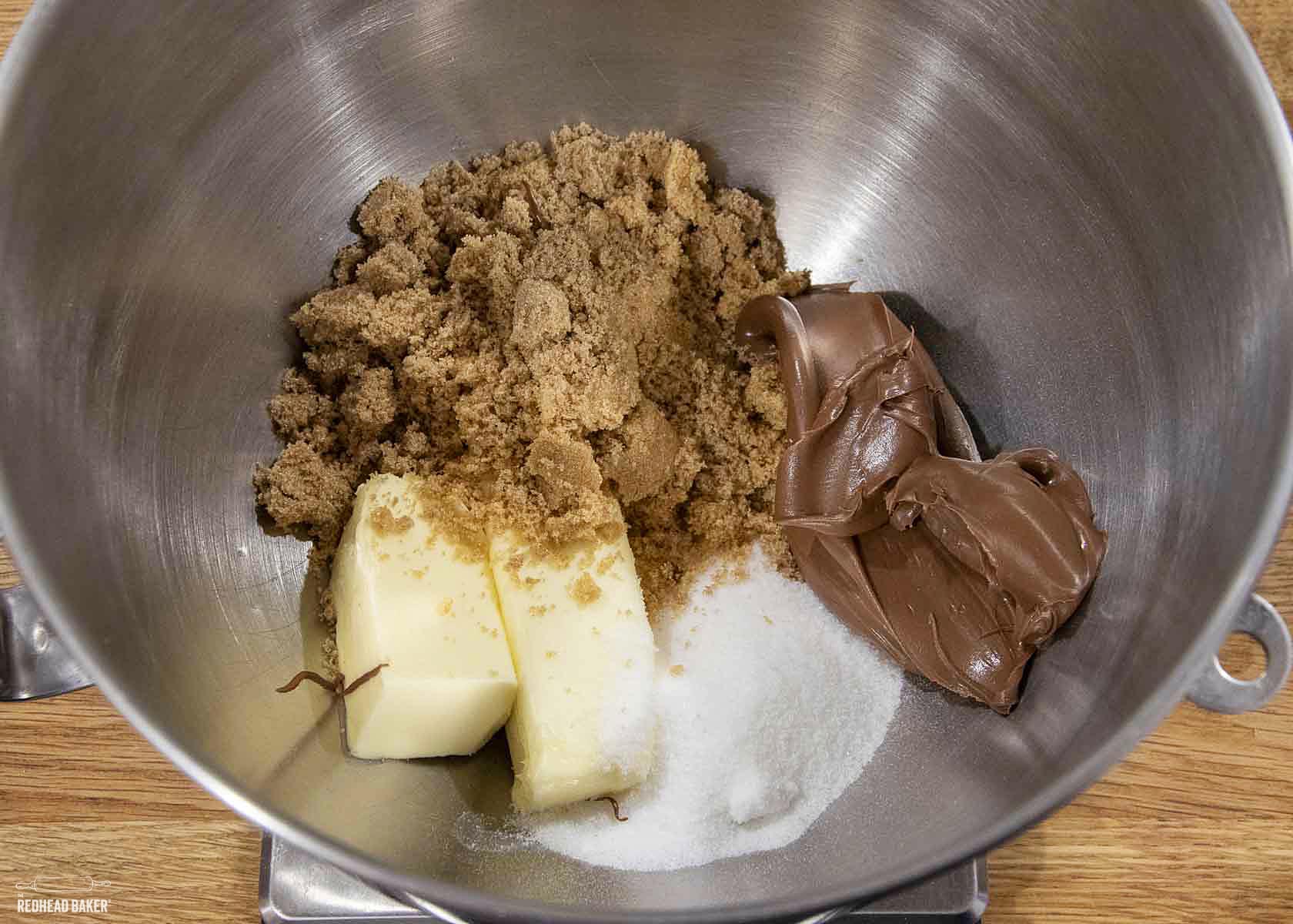 The first four ingredients for Nutella cookie dough: butter, brown sugar, Nutella and granulated white sugar.