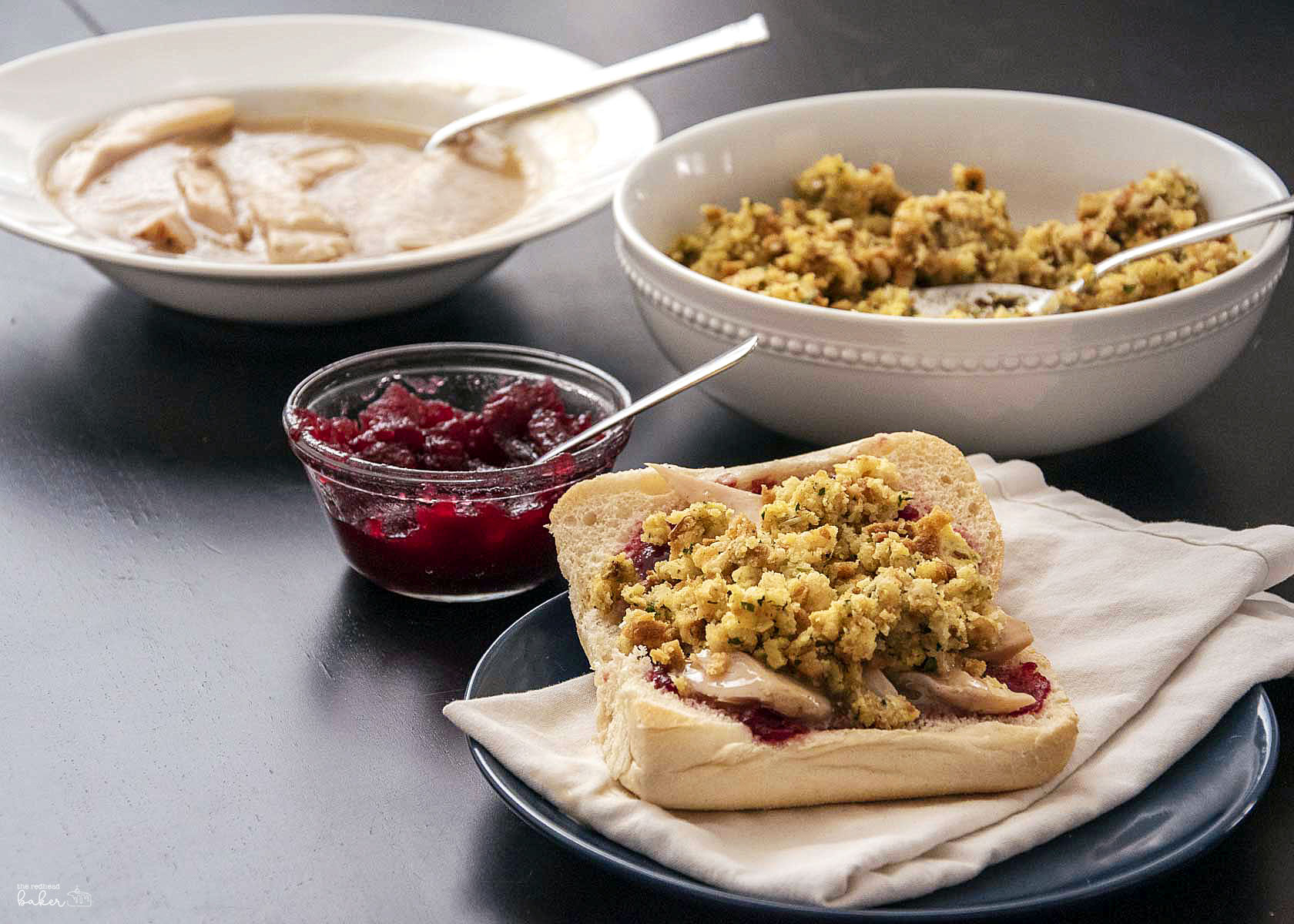 Leftover turkey and gravy, stuffing, cranberry sauce, and an assembled Thanksgiving leftovers sandwich.