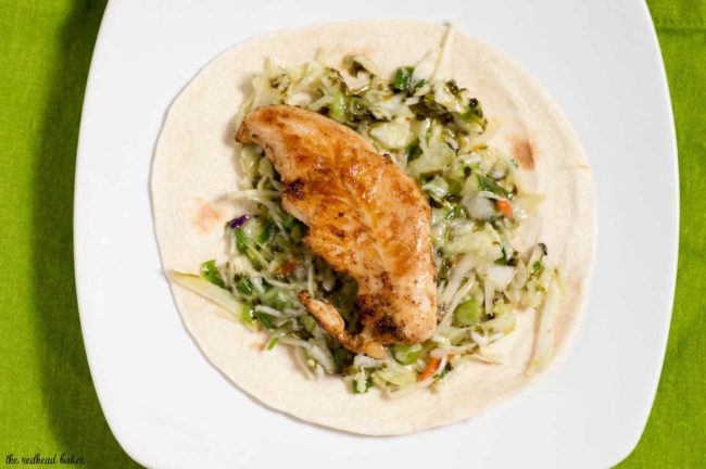 Chicken tacos are spiced with ancho chile powder and topped with cilantro slaw and avocado cream. This delicious meal is ready in under 30 minutes!