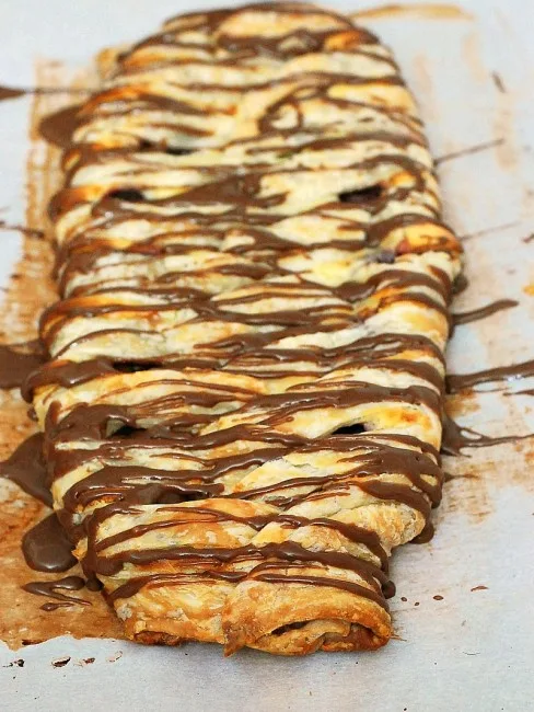 Honor the mothers in your life with this beautiful, decadent cherry cheesecake pastry braid drizzled with chocolate glaze. #SundaySupper theredheadbaker.com