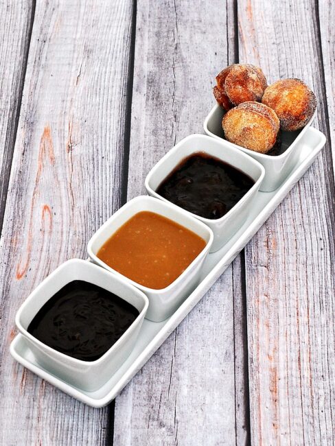 #BrunchWeek continues with sweet sugar-covered fried donut holes, served with three dipping sauces: caramel, chocolate, and blackberry. Bet you can't stop at just one! theredheadbaker.com