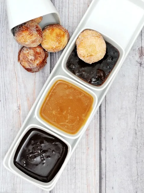 #BrunchWeek continues with sweet sugar-covered fried donut holes, served with three dipping sauces: caramel, chocolate, and blackberry. Bet you can't stop at just one! theredheadbaker.com