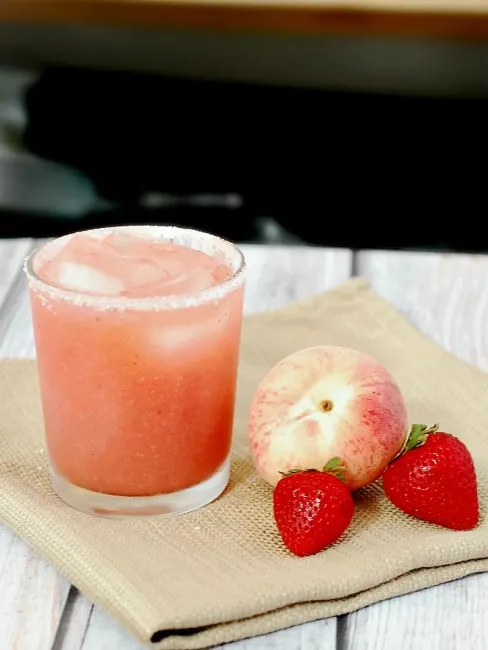 Set aside some fresh seasonal fruit for these strawberry-peach margaritas. They are light and refreshing, perfect for sipping on a warm summer night! 