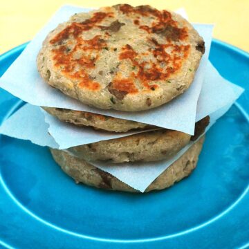 Scottish tattie scones, aka potato scones, resemble pancakes more than typical scones. They combine potatoes, flour, and butter and are sauteed on a griddle. #BrunchWeek theredheadbaker.com