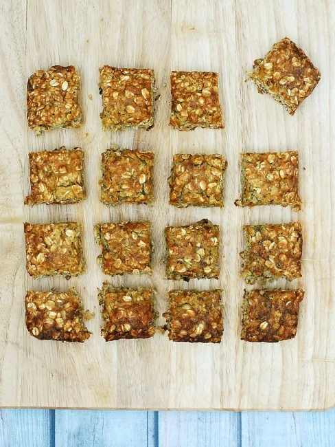 Use up an overripe banana in these tender, delicious banana-oatmeal squares. These treats are low-fat, so it's okay to eat two! theredheadbaker.com #CLBLogger