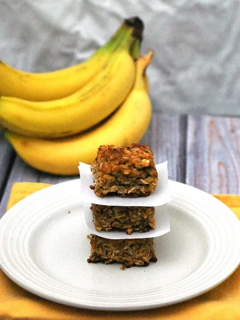 Use up an overripe banana in these tender, delicious banana-oatmeal squares. These treats are low-fat, so it's okay to eat two! theredheadbaker.com #CLBLogger