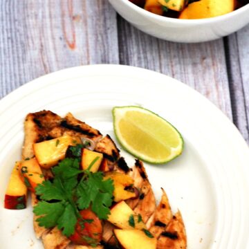 Grilled peach salsa adds a smoky sweet flavor to spiced chicken breasts. Use thin-sliced chicken breasts to cut down on cooking time. #CLBlogger