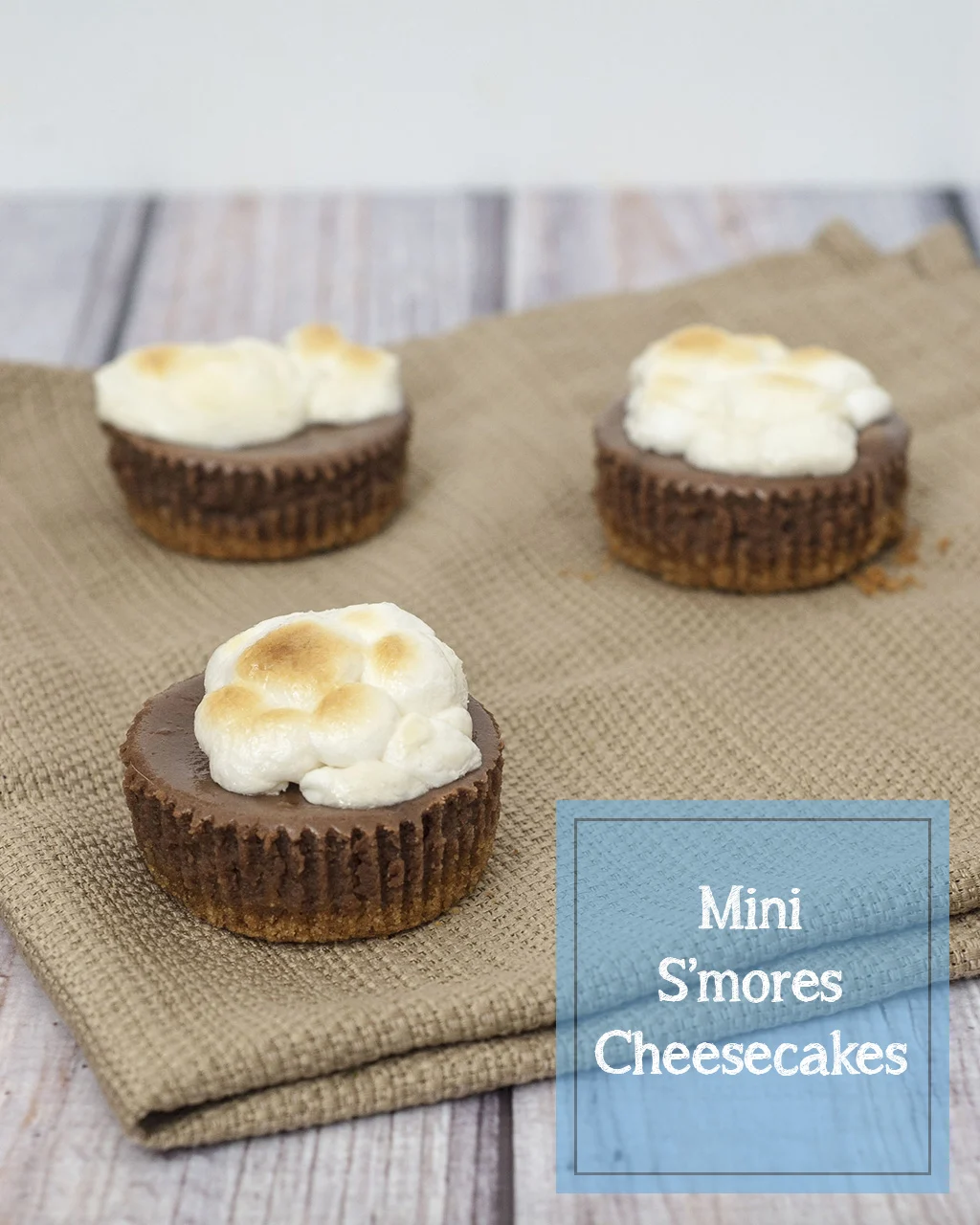 S'mores turn elegant in the form of mini chocolate cheesecakes with graham cracker crusts, topped with marshmallows toasted under the broiler. TheRedheadBaker.com #WhatsBaking