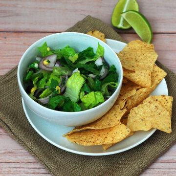 When the temperature rises, you need a meal that is filling, flavorful, and doesn't heat up your kitchen. This salad combines healthy veggies, beans, and a spicy dressing -- no cooking required! #WeekdaySupper TheRedheadBaker.com