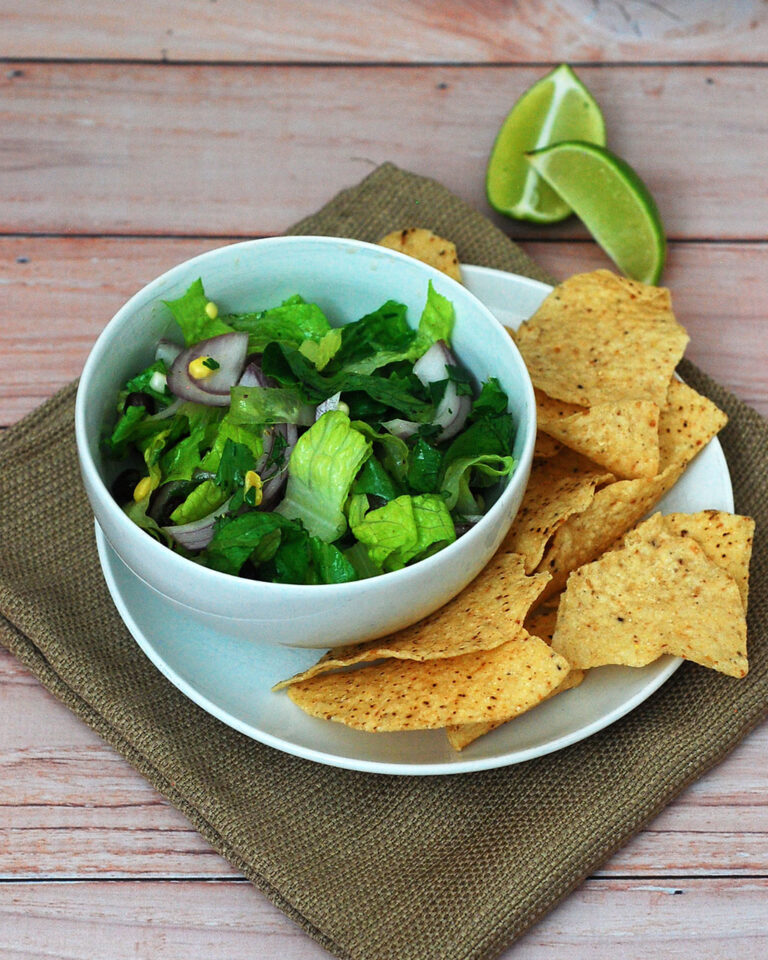 When the temperature rises, you need a meal that is filling, flavorful, and doesn't heat up your kitchen. This salad combines healthy veggies, beans, and a spicy dressing -- no cooking required! #WeekdaySupper TheRedheadBaker.com