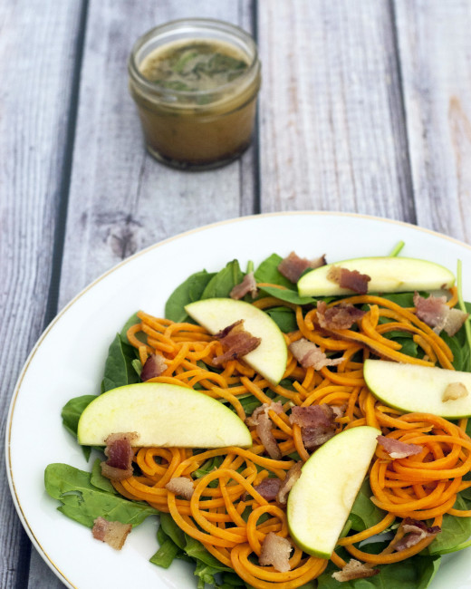 Sweet potato noodle salad swaps spiralized sweet potatos for pasta, served over spinach and apples with a delicious and tangy warm sage-brown-butter dressing. TheRedheadBaker.com