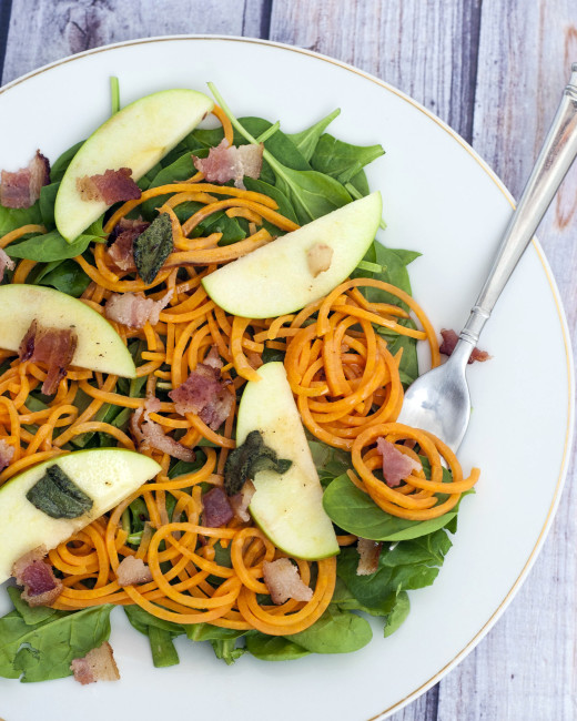 Sweet potato noodle salad swaps spiralized sweet potatos for pasta, served over spinach and apples with a delicious and tangy warm sage-brown-butter dressing. TheRedheadBaker.com