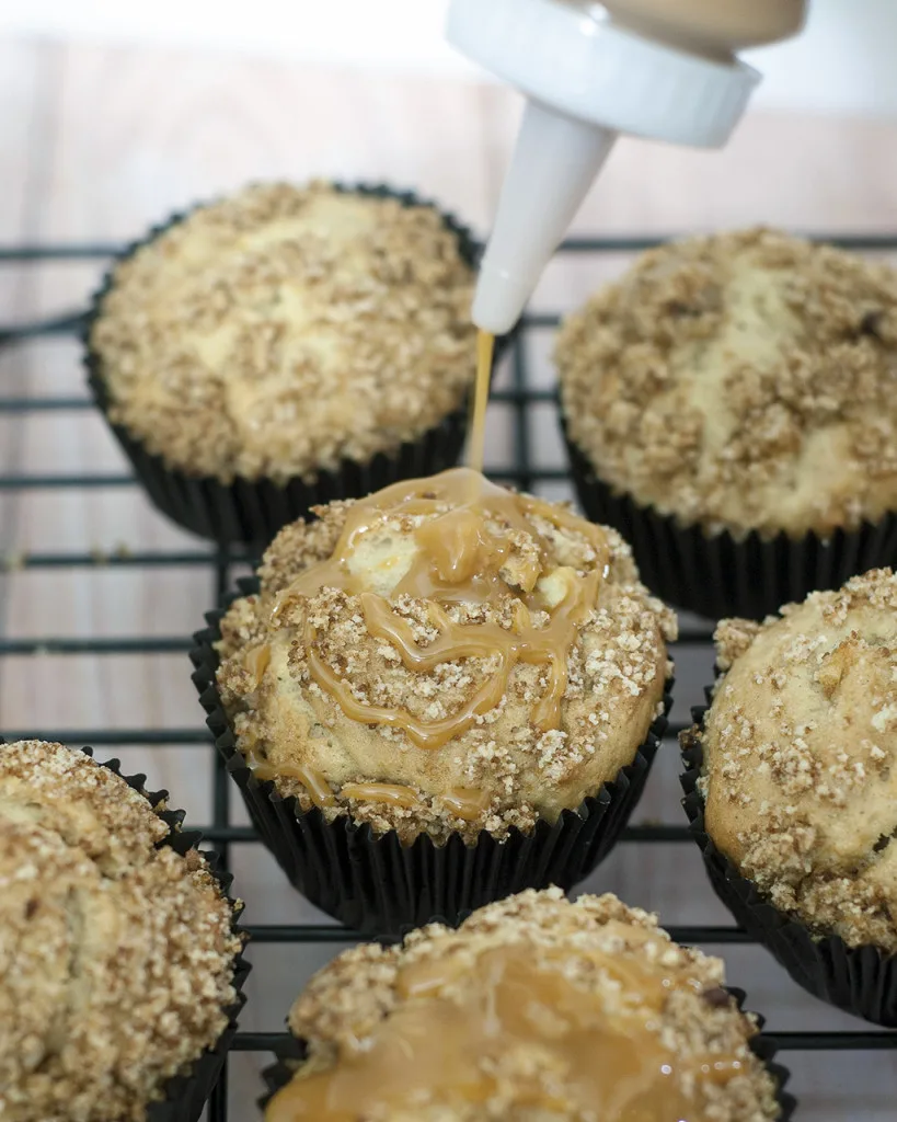 Autumn means apples are in season. Enjoy them in these easy-to-make quintessential fall breakfast muffins: caramel apple streusel muffins. #SundaySupper TheRedheadBaker.com