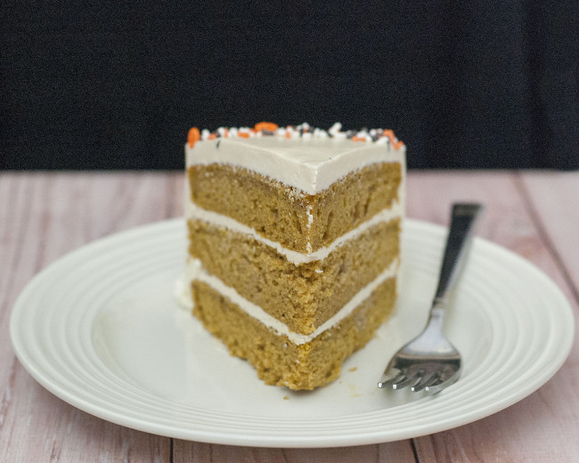 Pumpkin Cake with Salted Caramel Icing is a decadent fall treat. Three layers of moist pumpkin cake is layered with satin-smooth salted caramel Swiss buttercream. #PumpkinWeek