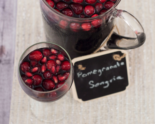 Pomegranate sangria combines fruity red wine with pomegranate and cranberry, with cinnamon for a hint of spice. Make a large batch a day ahead for a winning party cocktail! #SundaySupper TheRedheadBaker.com