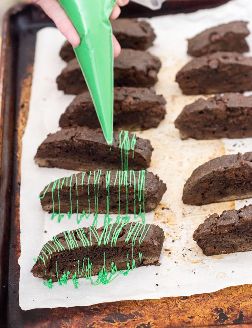 Italian-style biscotti is the perfect accompaniment for your afternoon cup of coffee! This cookie is flavored with dark chocolate cocoa powder and mint-flavored chocolate morsels. TheRedheadBaker #WhatsBaking