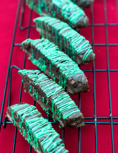 Italian-style biscotti is the perfect accompaniment for your afternoon cup of coffee! This cookie is flavored with dark chocolate cocoa powder and mint-flavored chocolate morsels. TheRedheadBaker #WhatsBaking