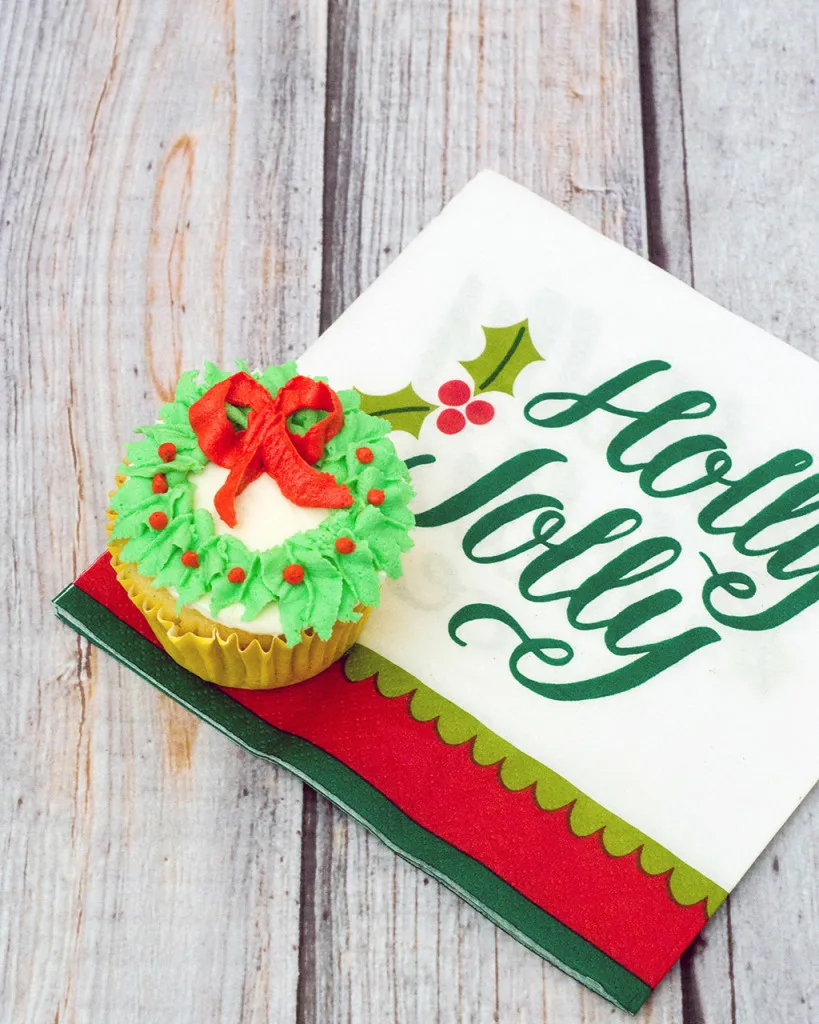 In this Christmas Wreath Cupcake tutorial, I show you how to turn your favorite cupcake into a festive Christmas wreath with some red and green icing and a few simple tools.