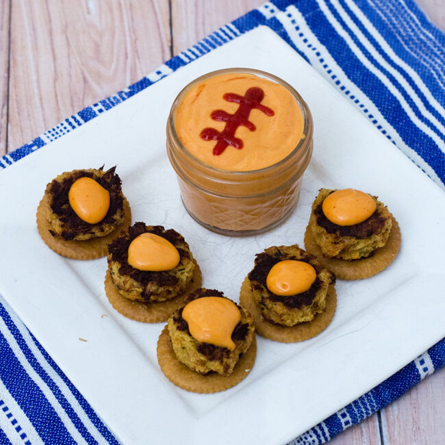 Bring some heat to your bowl game party with mini crab cakes served on RITZ® crackers, topped with spicy sriracha aioli. TheRedheadBaker.com #BowlTimeSnacks #ad