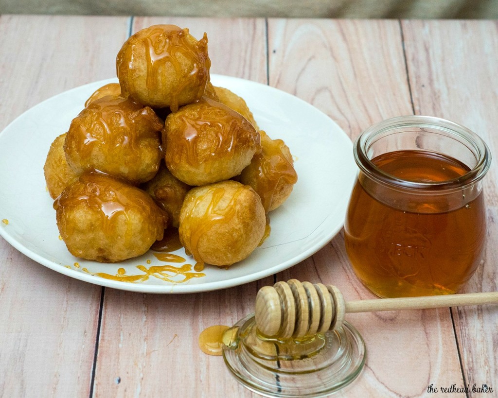 Light, airy puffs of dough are fried, then coated in a sweet honey syrup. Greeks traditionally served them as dessert, but they're equally delicious at breakfast! #SundaySupper TheRedheadBaker.com
