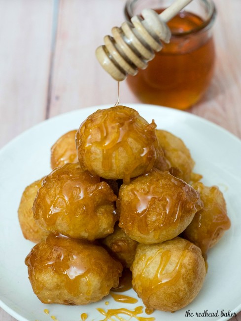 Light, airy puffs of dough are fried, then coated in a sweet honey syrup. Greeks traditionally served them as dessert, but they're equally delicious at breakfast! #SundaySupper TheRedheadBaker.com