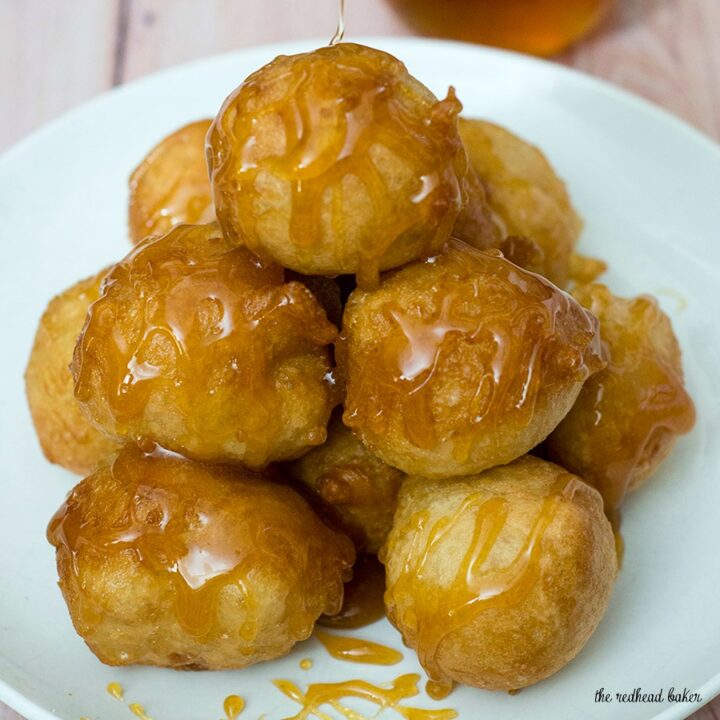 Light, airy puffs of dough are fried, then coated in a sweet honey syrup. Greeks traditionally served them as dessert, but they're equally delicious at breakfast! #SundaySupper TheRedheadBaker.com