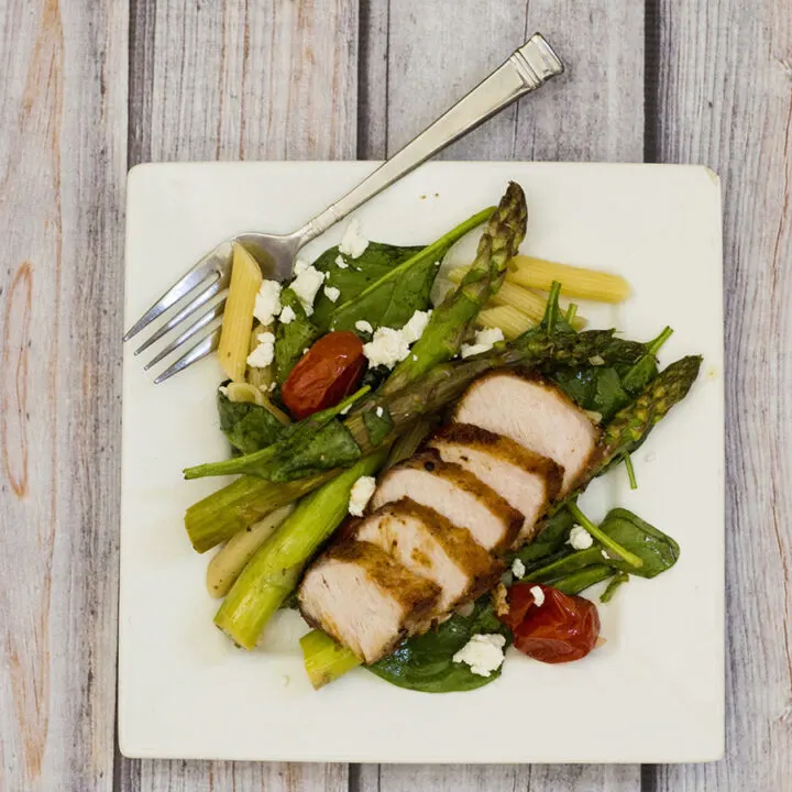 This versatile pasta salad combines roasted asparagus and tomatoes with penne and spinach, dressed in a low-calorie lemon vinaigrette. #CLBlogger TheRedheadBaker.com