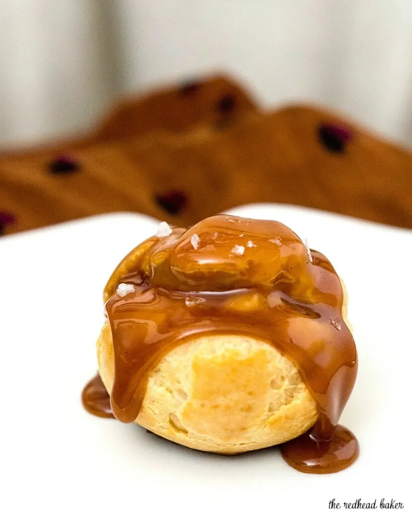 Finger food can be dessert, too! Bite-size salted caramel cream puffs are the perfect balance of salty and sweet flavors. #SundaySupper TheRedheadBaker.com