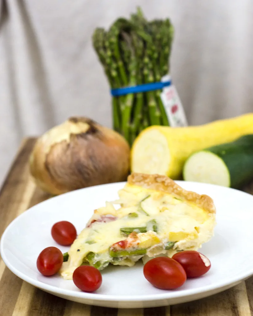 This veggie quiche is loaded with the freshest spring produce. It's a perfect make-ahead meal for breakfast, brunch or dinner! #WhatsBaking