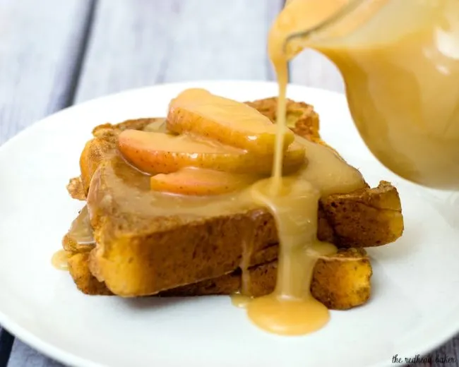 Rich slices of French toast are topped with vanilla-apple compote and caramel syrup. The compote and syrup can be made ahead and rewarmed before serving. #BrunchWeek TheRedheadBaker.com