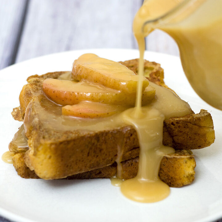 Rich slices of French toast are topped with vanilla-apple compote and caramel syrup. The compote and syrup can be made ahead and rewarmed before serving. #BrunchWeek TheRedheadBaker.com