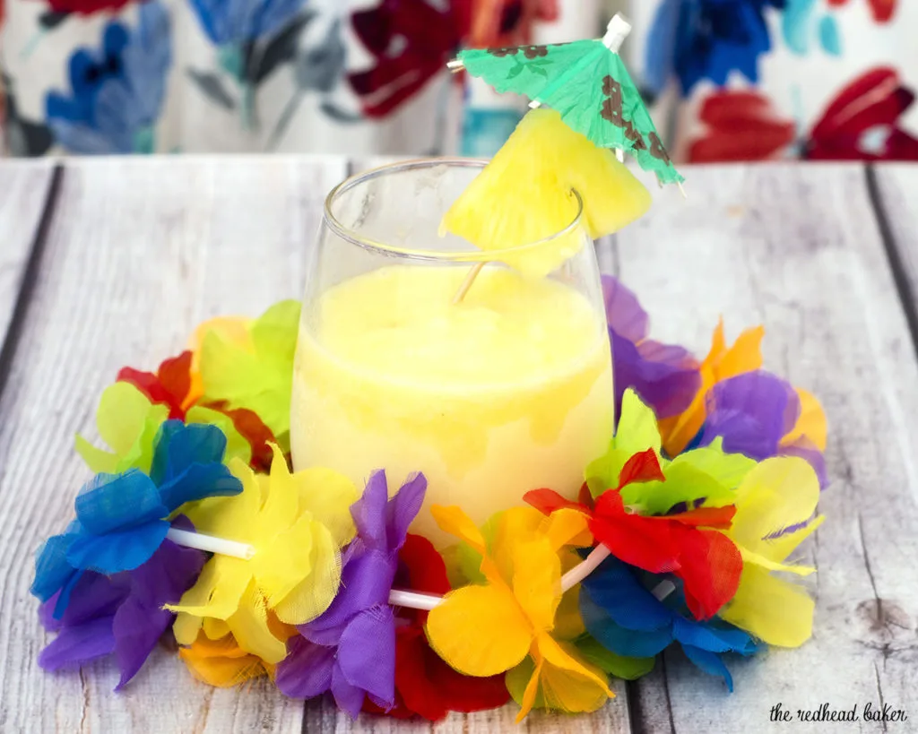 Have a taste of the tropics with a homemade frozen pina colada: a blend of ice, pineapple slices and juice, coconut cream and rum. #SundaySupper TheRedheadBaker.com