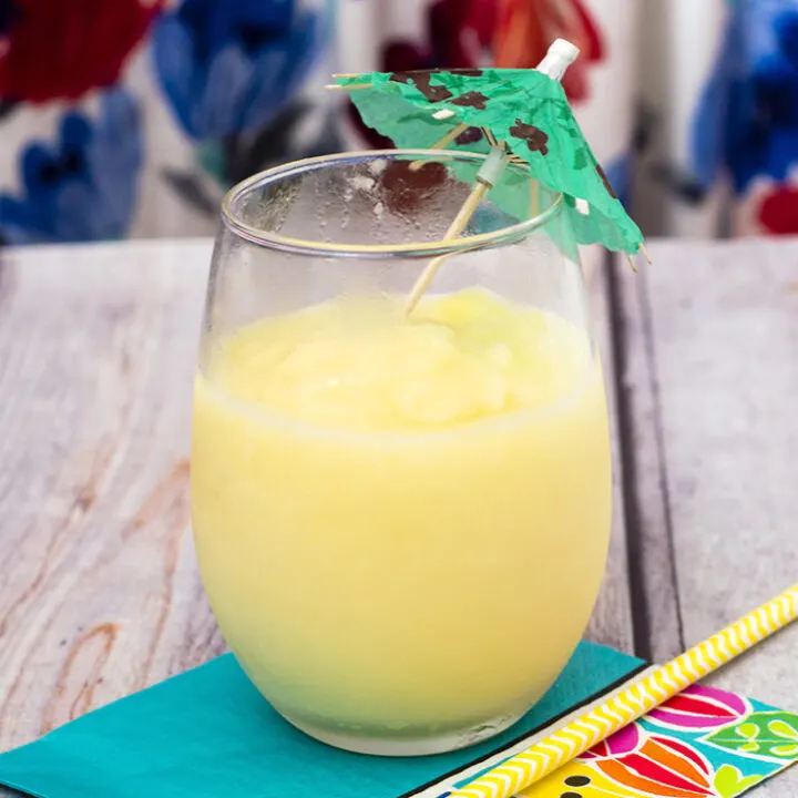 Have a taste of the tropics with a homemade frozen pina colada: a blend of ice, pineapple slices and juice, coconut cream and rum. #SundaySupper TheRedheadBaker.com