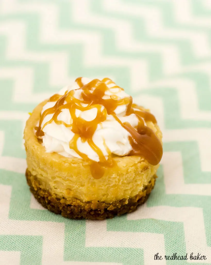 Finish off a tapas-style meal with mini dulce de leche cheesecakes — individual-sized creamy caramel-flavored cheesecakes with a cinnamon-crumb crust. #SundaySupper TheRedheadBaker.com