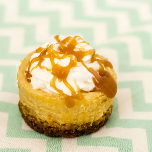 Finish off a tapas-style meal with mini dulce de leche cheesecakes &mdash; individual-sized creamy caramel-flavored cheesecakes with a cinnamon-crumb crust. #SundaySupper TheRedheadBaker.com