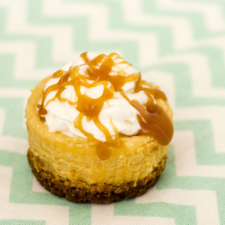 Finish off a tapas-style meal with mini dulce de leche cheesecakes — individual-sized creamy caramel-flavored cheesecakes with a cinnamon-crumb crust. #SundaySupper TheRedheadBaker.com