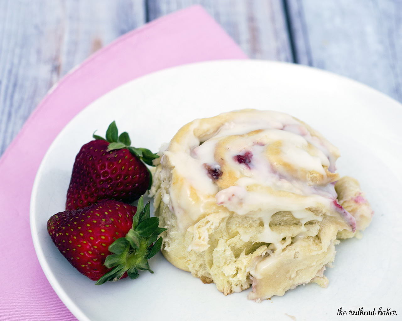 With summer on the way, give your sweet rolls a seasonal twist: fill them with fresh strawberries and sweetened cream cheese, then top with a sweet-tart lemon-flavored simple icing. #BrunchWeek TheRedheadBaker.com