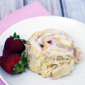 With summer on the way, give your sweet rolls a seasonal twist: fill them with fresh strawberries and sweetened cream cheese, then top with a sweet-tart lemon-flavored simple icing. #BrunchWeek TheRedheadBaker.com