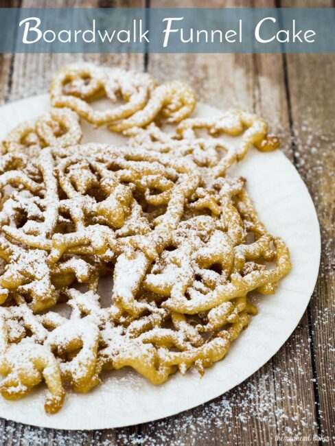 Boardwalk funnel cake takes me back to childhood vacations at a New Jersey beach. This warm deep-fried treat is dusted with powdered sugar and great for sharing! #SundaySupper TheRedheadBaker.com