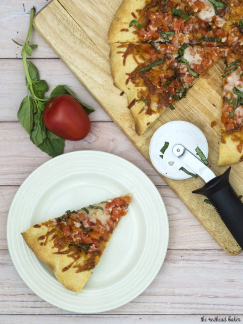 Bruschetta pizza is loaded with fresh summer tomatoes, basil and garlic over lots of melted mozzarella cheese. What better flavor for summer pizza? #ProgressiveEats